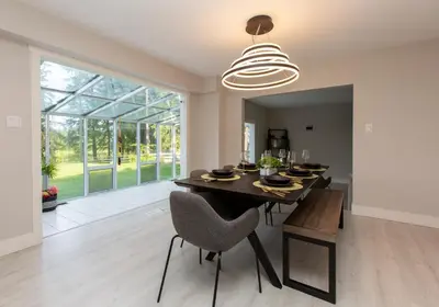 a dining room with a table and chairs and a large window at Modern 5BR Luxury Getaway in Cobble Hill
