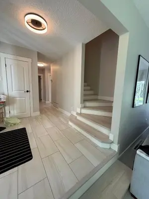 an empty living room with a staircase in a house at Modern 5BR Luxury Getaway in Cobble Hill