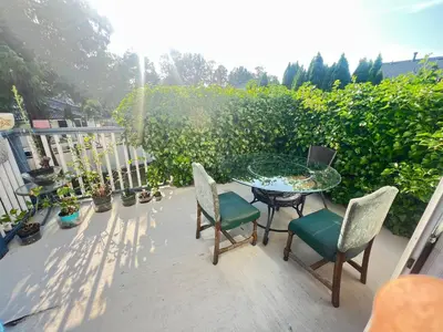 a patio with a glass table and chairs on a balcony at Cozy Nook in Fraser Valley Getaway with Breakfast in Abbotsford