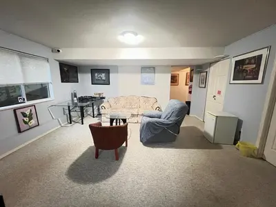 a living room with a couch and a table at Cozy Nook in Fraser Valley Getaway with Breakfast in Abbotsford