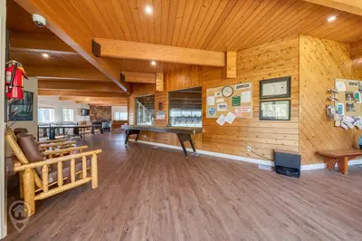 a large room with wooden walls and wooden floors at Akiskinook Resort by StayIn in Windermere