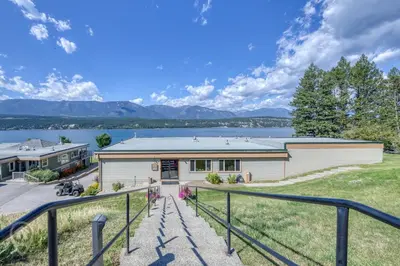 a home with a view of a lake and mountains at Akiskinook Resort by StayIn in Windermere