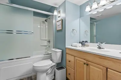 a bathroom with a white toilet and a sink at Private Family Entertainer's Suite in Calgary