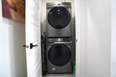 two washing machines sitting next to each other at The Cozy Nook of Seton in Calgary