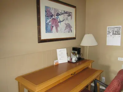 a desk in a hotel room with a coffee maker on it at Bulkley Valley Motel in New Hazelton