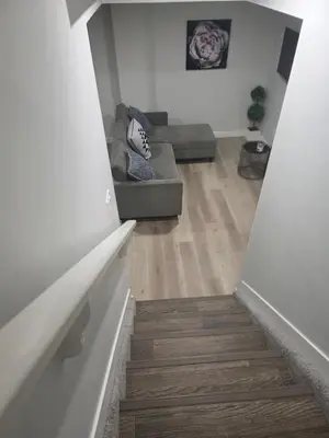 a stairway leading to a living room with a couch at Cozy Up in Edmonton