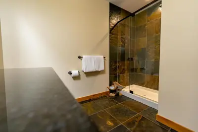 a bathroom with a shower and a toilet at Creekside 2-Bedroom Condo in Canmore