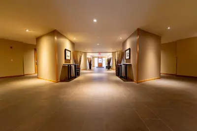an empty room with a large room with a hallway at Creekside 2-Bedroom Condo in Canmore