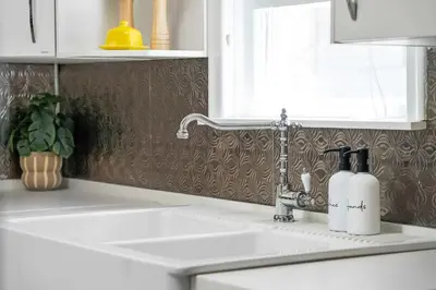 a kitchen sink with a faucet next to a sink at The Canary 2BR Gem in Downtown Drumheller in Drumheller