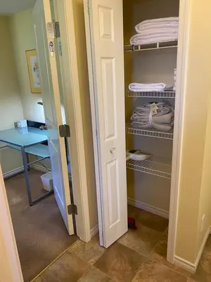 a closet with a door open to a room at Ravens Nest Cozy Lower One Bedroom Suite in Victoria