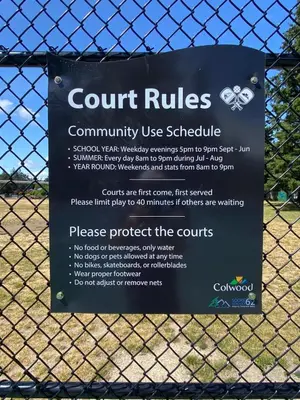 a sign on a fence that reads court rulescommunity use schedule at Ravens Nest Cozy Lower One Bedroom Suite in Victoria