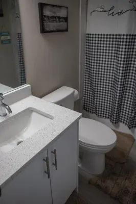 a bathroom with a sink and a toilet and a shower at Modern 2-Bedroom Suite with Private Access - 10 minutes from Calgary Airport in Calgary