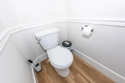 a bathroom with a toilet and a roll of toilet paper at Valley Villa Spacious 5BD Getaway! Sleep 12, 1hr to Banff, 40 Mins Canmore, 5 mins to WinSport & Olympic park in Calgary