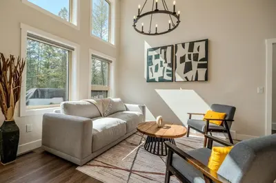 a living room with a couch and a table at Mountain View Hideaway - BBQ, Beach Access in Invermere