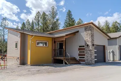a small house with a yellow and white at Mountain View Hideaway - BBQ, Beach Access in Invermere