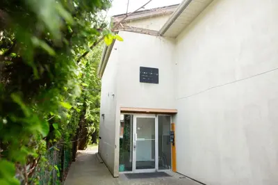an entrance to a white building with a glass door at The Riverbend Modern Studio at Harrison Lake in Harrison Hot Springs