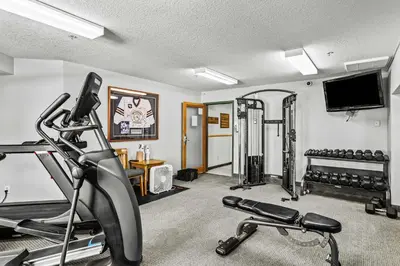 a fitness room with a gym with tread machines at Mountain Views Balcony and Free Parking in Canmore