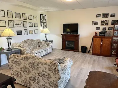 a living room with two couches and a television at The Flight Line in Calgary