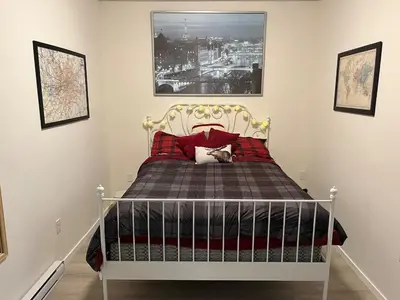 a bedroom with a bed with red pillows at The Flight Line in Calgary