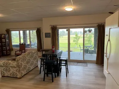 a living room with a couch and a table and chairs at The Flight Line in Calgary