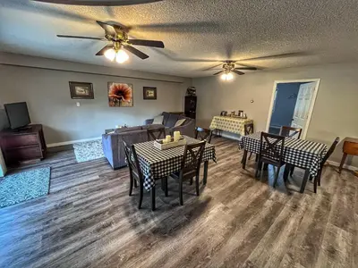 a living room with tables and chairs and a couch at Sunny Shuswap B&B in Chase