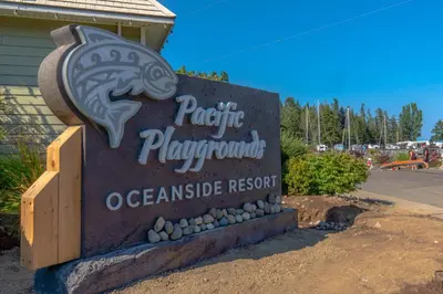 a sign for a resort with a fish on it at I Beach You To It in Oyster Bay