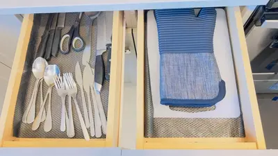 a wooden drawer with utensils in a cabinet at Calgary Airport Getaway Spacious 3BR Full Home in Calgary