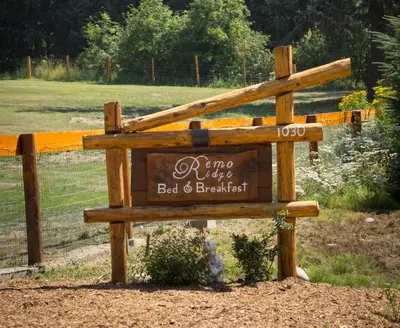 a wooden sign for a bed and breakfast at Remo Ridge Bed N Breakfast in Terrace