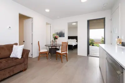 a living room with a couch and a table with chairs at New 2BR Suite With Great Ocean View in West Vancouver in West Vancouver