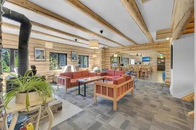 a living room with couches and a dining room at HI Nordegg - Hostel in Nordegg