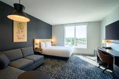 a hotel room with a bed and a couch at Hyatt Place Whitehorse in Whitehorse
