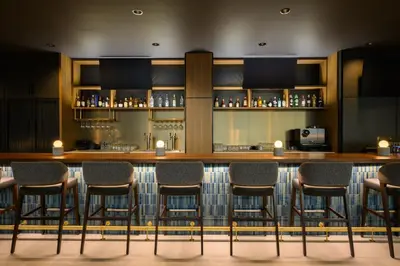 a bar with stools in a restaurant at Hyatt Place Whitehorse in Whitehorse