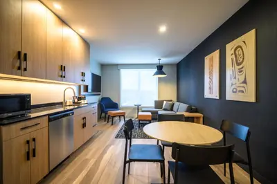 a kitchen and living room with a table and chairs at Hyatt Place Whitehorse in Whitehorse