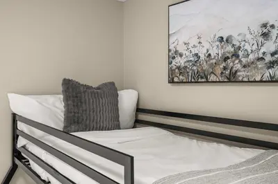 a bedroom with a bed and a painting on the wall at Social Haus Trendy 3BR Townhome in Bridgeland YYC in Calgary
