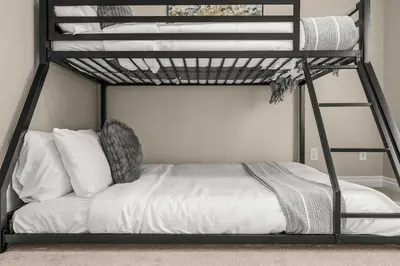 a bedroom with a bunk bed with white sheets at Social Haus Trendy 3BR Townhome in Bridgeland YYC in Calgary