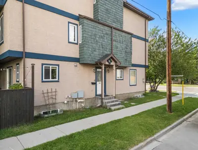 a building with a green roof and a sidewalk at Social Haus Trendy 3BR Townhome in Bridgeland YYC in Calgary