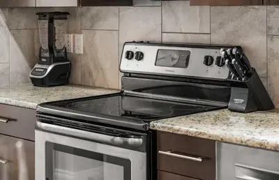 a stove top oven in a kitchen with a microwave at Social Haus Trendy 3BR Townhome in Bridgeland YYC in Calgary