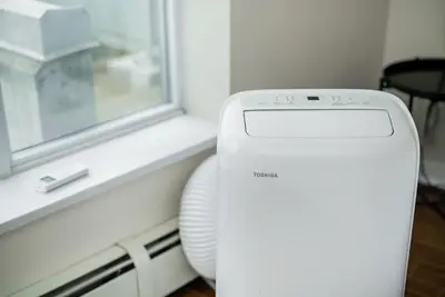 a white printer sitting next to a window at Spacious Downtown Condo with Pool Gym & Parking in Vancouver