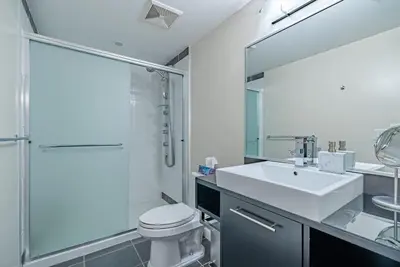 a bathroom with a toilet and a sink and a shower at Downtown Condo with Great City Views in Vancouver