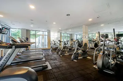 a gym with several treadmills and machines in it at Downtown Condo with Great City Views in Vancouver