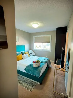 a bedroom with a bed with a basket of fruit on it at Stonecroft House in Calgary