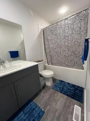 a bathroom with a toilet and a sink and a shower at Home in west Edmonton in Edmonton