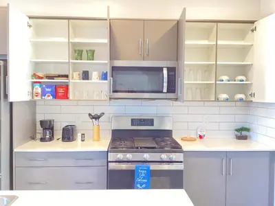 a kitchen with a stove and a microwave at single house in Edmonton