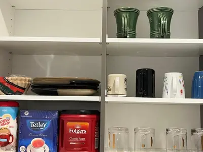 a shelf with green glasses and cups on it at single house in Edmonton