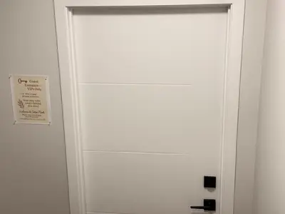 a white door with a sign on it at The Seton Nook - 1BR Suite Near Seton Health Campus, Cineplex and YMCA in Calgary