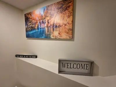 a wall with a sign that says welcome at Haven YYC Guest Suite in Northwest Calgary in Calgary