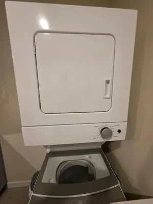 a toilet in a bathroom with a white tank at Haven YYC Guest Suite in Northwest Calgary in Calgary
