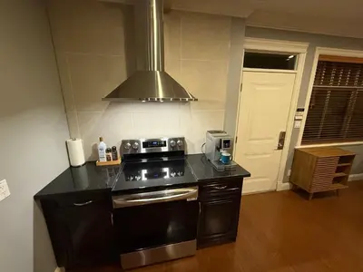 a kitchen with a stove and a stove top oven at Peaceful & Cozy Home with 3 rooms, SHARED Bathrooms and SHARED Common Space in Vancouver