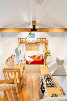 a view of the living room and kitchen of a tiny house at Riverwood Retreat-hot tub and cedar sauna on the river in Squamish