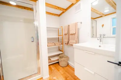 a bathroom with a sink and a shower at Riverwood Retreat-hot tub and cedar sauna on the river in Squamish